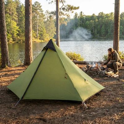 Femme entretient feu derrière tente 1 place