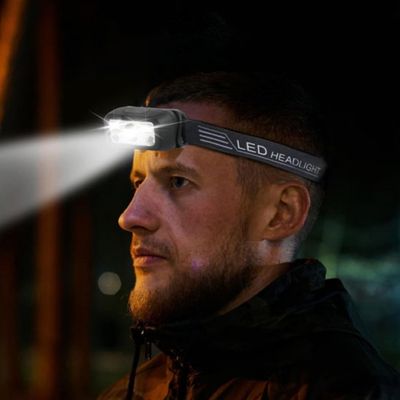 Homme lampe frontale rechargeable concentré course orientation nuit