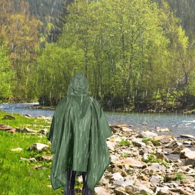 Homme marche avec poncho de pluie bord rivière