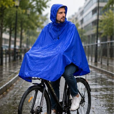 Homme poncho pluie velo roule piste cyclable