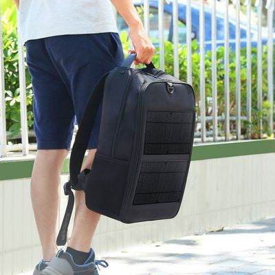 Homme porte sac a dos solaire par poignée main